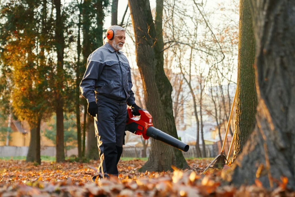 Man working with leaf blower to clean up alleys.